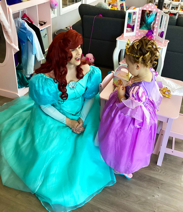 princess ariel character singing with little princess girl