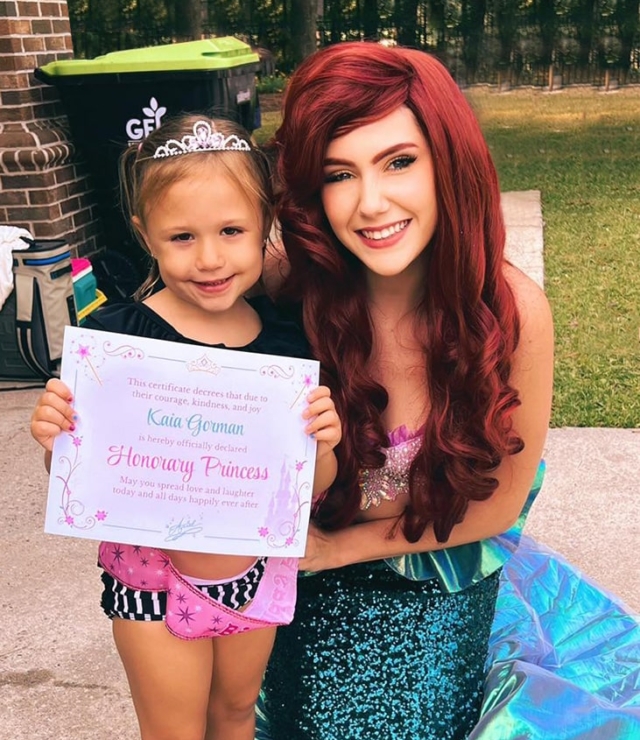 ariel princess with little girl holding princess certificate