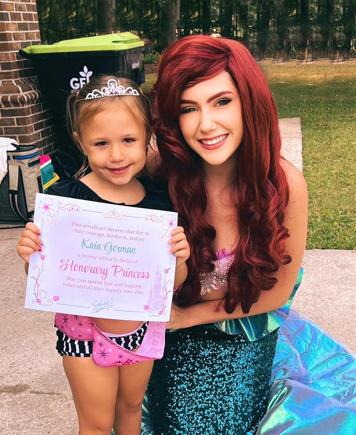 ariel princess with little girl holding princess certificate