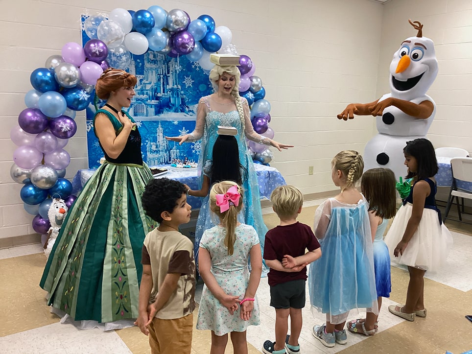 snow sisters and happy snowman at birthday party